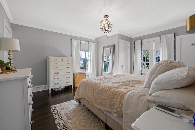 bedroom with a chandelier, dark hardwood / wood-style floors, and crown molding