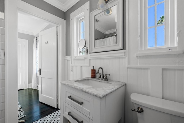 bathroom featuring vanity, toilet, and ornamental molding