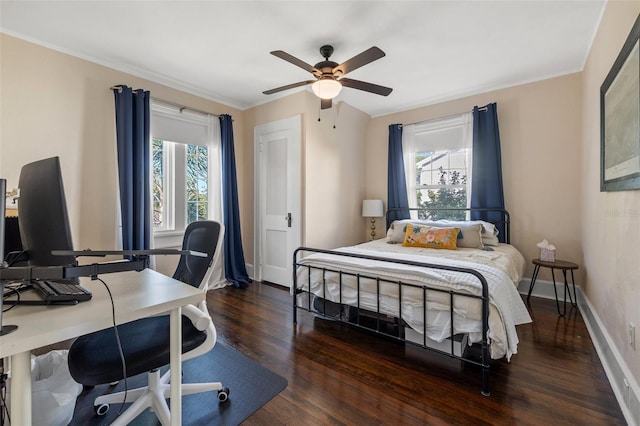 bedroom with dark hardwood / wood-style floors, ceiling fan, and crown molding