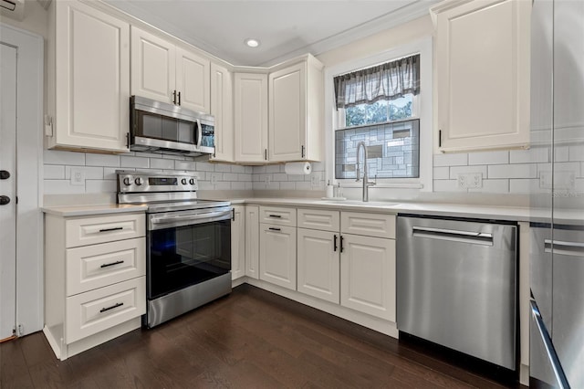 kitchen with white cabinets, backsplash, stainless steel appliances, and sink