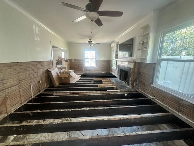 miscellaneous room with built in shelves, ceiling fan, and ornamental molding