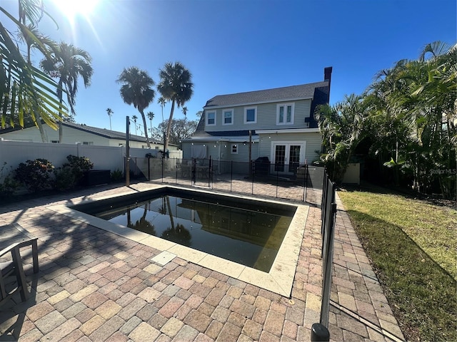 view of pool featuring a patio area and french doors