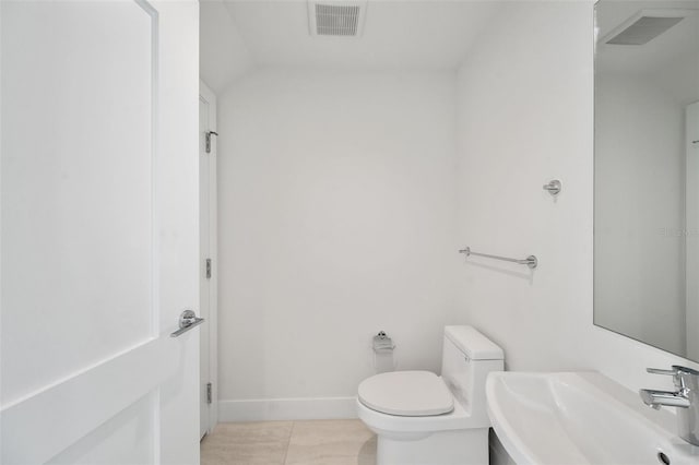 bathroom with tile patterned flooring, toilet, and sink