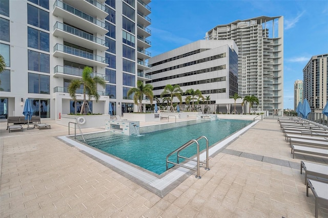 view of swimming pool featuring a patio area and pool water feature