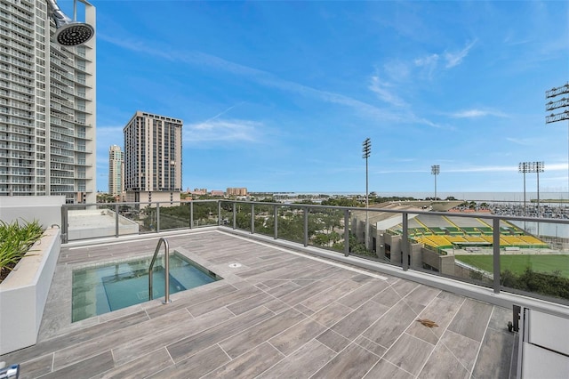 view of swimming pool featuring a hot tub