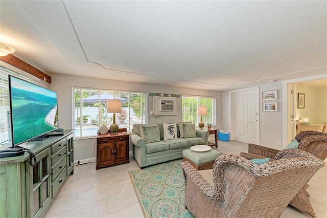 tiled living room featuring a wall mounted air conditioner and a textured ceiling