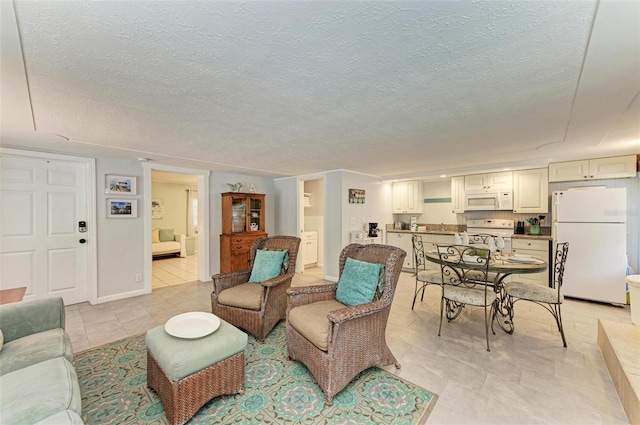 living room featuring light tile patterned floors and a textured ceiling