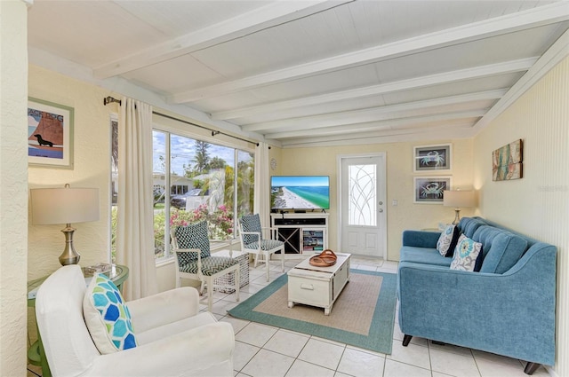 living room featuring beamed ceiling, a healthy amount of sunlight, and light tile patterned floors