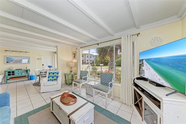 living room featuring beamed ceiling and light tile patterned floors