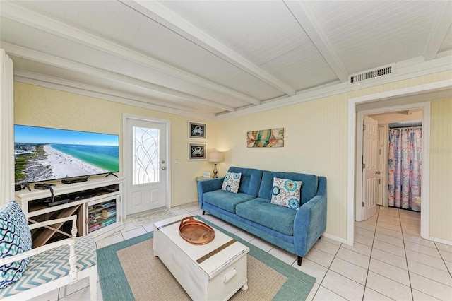 living room featuring light tile patterned floors and beam ceiling