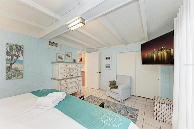 tiled bedroom with beam ceiling