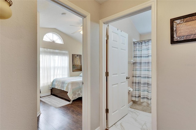 hallway with vaulted ceiling