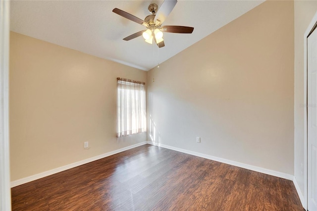 empty room with vaulted ceiling, dark wood-type flooring, and ceiling fan