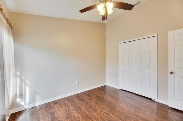 unfurnished bedroom featuring dark wood-type flooring, ceiling fan, and a closet