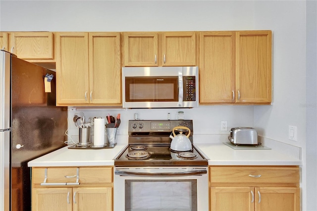 kitchen featuring stainless steel appliances and light brown cabinets