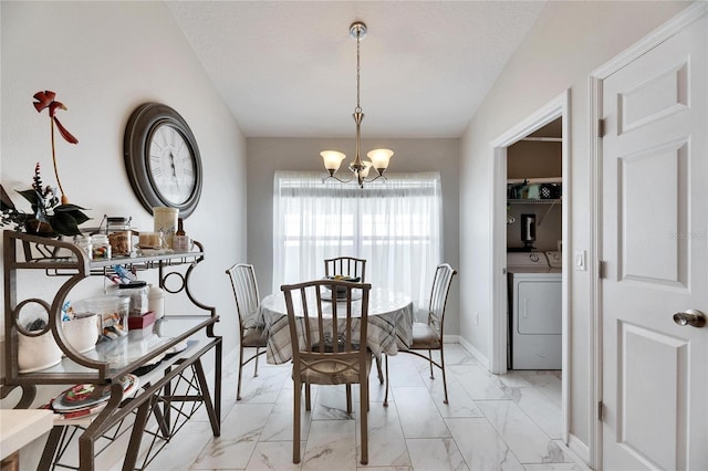 dining space featuring washer / dryer, a notable chandelier, and a textured ceiling