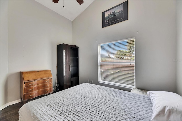 bedroom with high vaulted ceiling, dark hardwood / wood-style floors, and ceiling fan