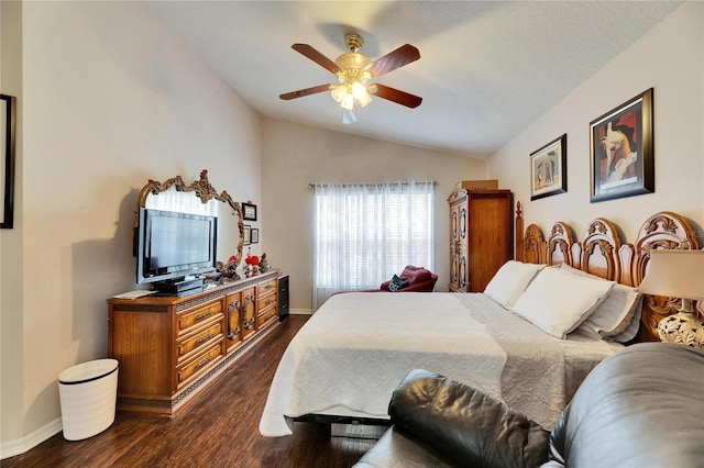 bedroom with ceiling fan, lofted ceiling, and dark hardwood / wood-style floors