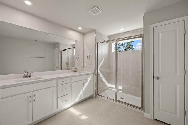 bathroom featuring tile patterned floors, vanity, and an enclosed shower