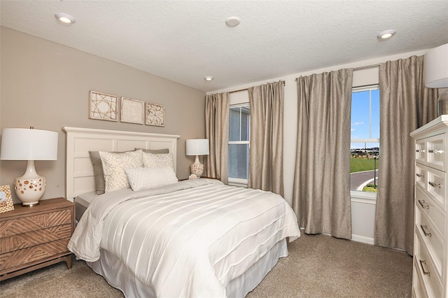 carpeted bedroom with a textured ceiling