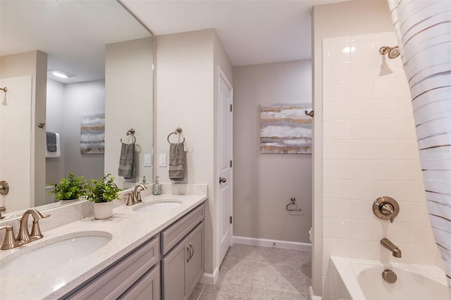 full bathroom with tile patterned flooring, vanity,  shower combination, and toilet