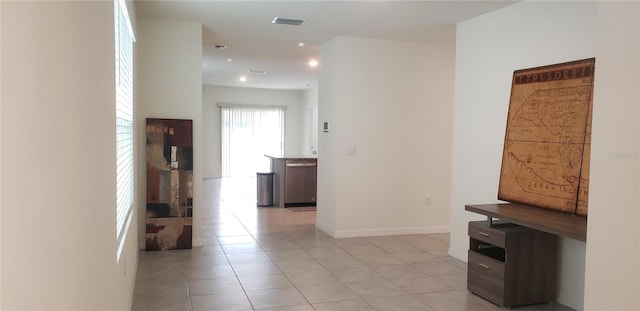 hall featuring light tile patterned floors