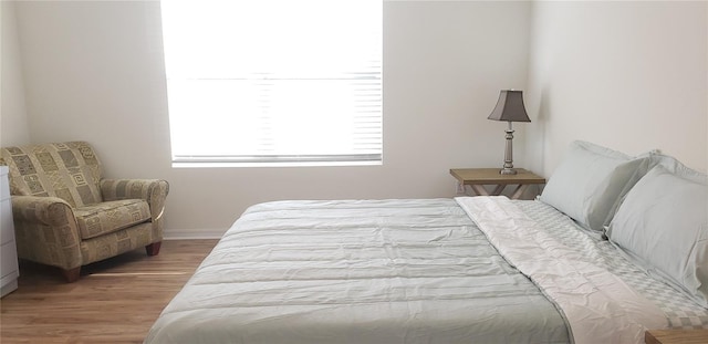 bedroom with hardwood / wood-style flooring