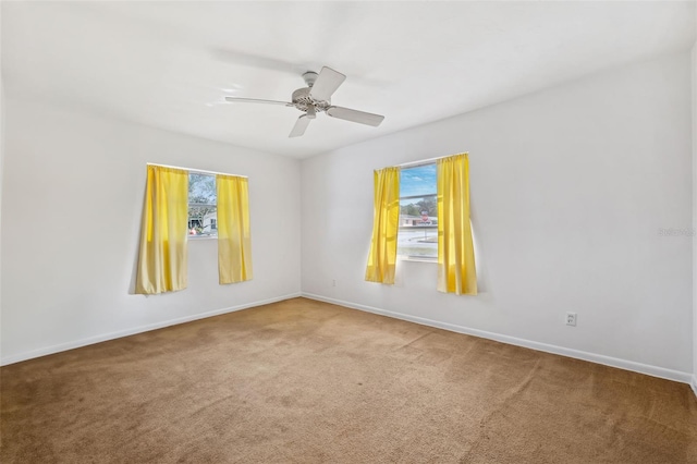 unfurnished room featuring ceiling fan and carpet