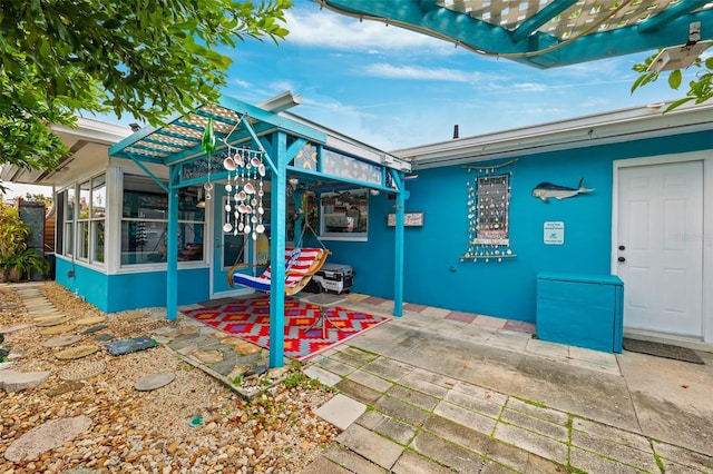 view of patio / terrace with a sunroom