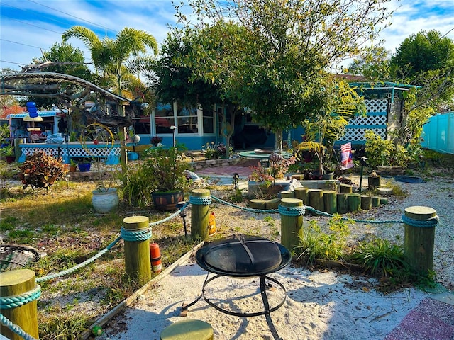 view of yard featuring an outdoor fire pit