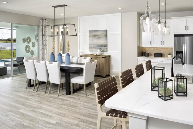 12458 49th St E, Parrish, FL 34219 - dining area with a chandelier, recessed lighting, and light wood-style floors