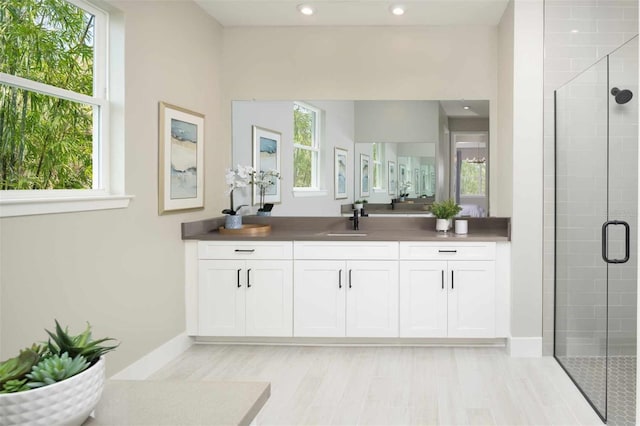 12458 49th St E, Parrish, FL 34219 - full bathroom with vanity, a stall shower, recessed lighting, and wood finished floors