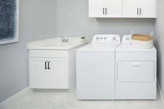 12458 49th St E, Parrish, FL 34219 - laundry area featuring washing machine and clothes dryer, light marble finish floors, and cabinet space