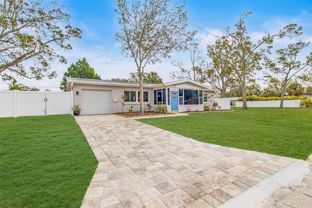 ranch-style home with a front lawn and a garage