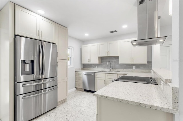 kitchen featuring white cabinets, appliances with stainless steel finishes, tasteful backsplash, sink, and island range hood