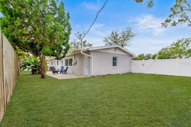 back of property with a patio area and a yard