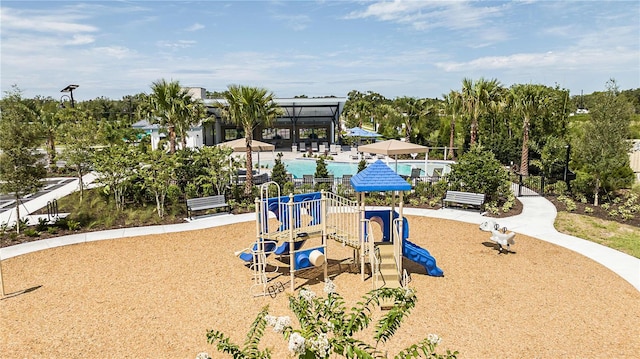 view of jungle gym with a lanai and a swimming pool