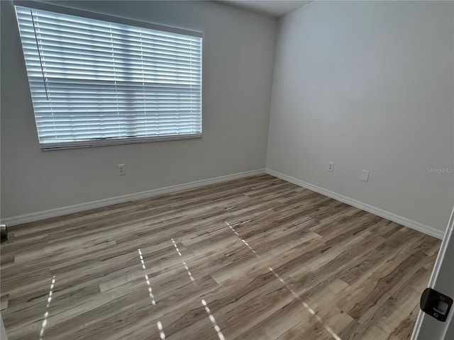 empty room with wood-type flooring