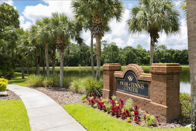 community / neighborhood sign with a water view