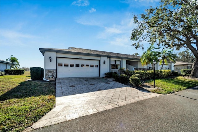 single story home with a garage and a front lawn