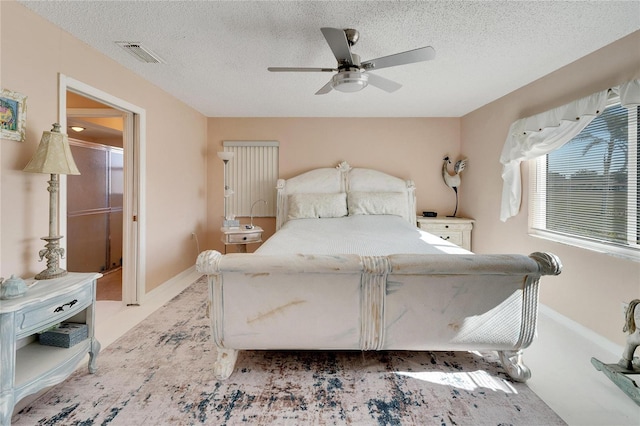 bedroom featuring a textured ceiling and ceiling fan