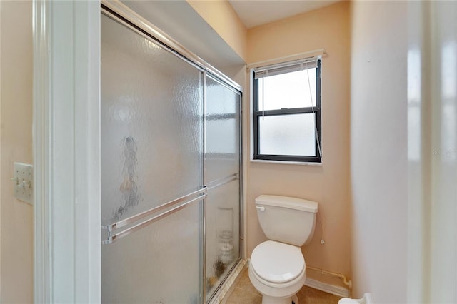 bathroom with walk in shower, tile patterned floors, and toilet