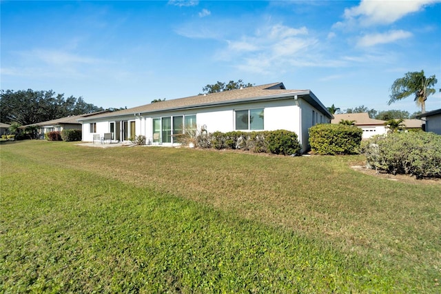 rear view of house with a lawn