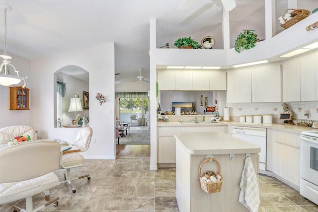 kitchen with a center island, white appliances, sink, decorative light fixtures, and kitchen peninsula