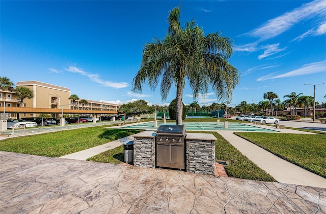 view of home's community featuring a lawn and exterior kitchen