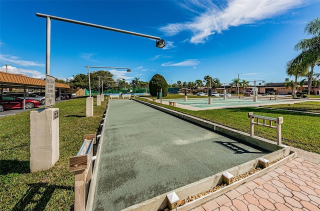 view of property's community with a lawn