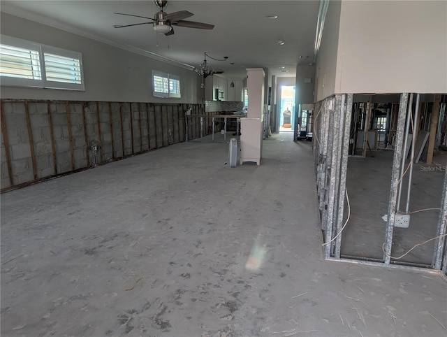 basement featuring crown molding and ceiling fan