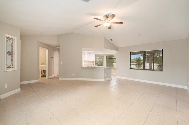 unfurnished living room with light tile patterned floors, vaulted ceiling, and ceiling fan