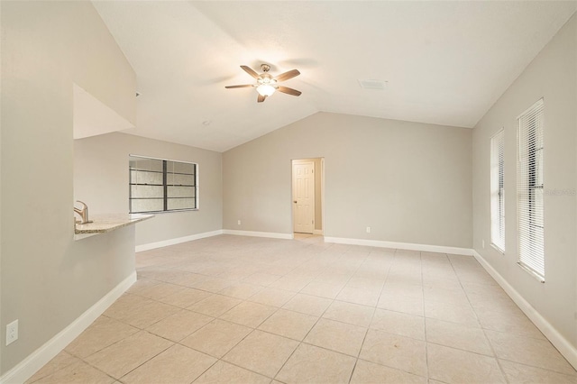 unfurnished room featuring light tile patterned floors, ceiling fan, and lofted ceiling