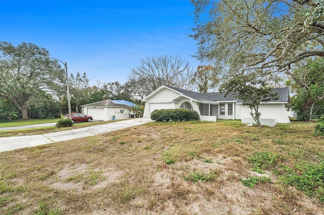 single story home featuring a garage and a front yard